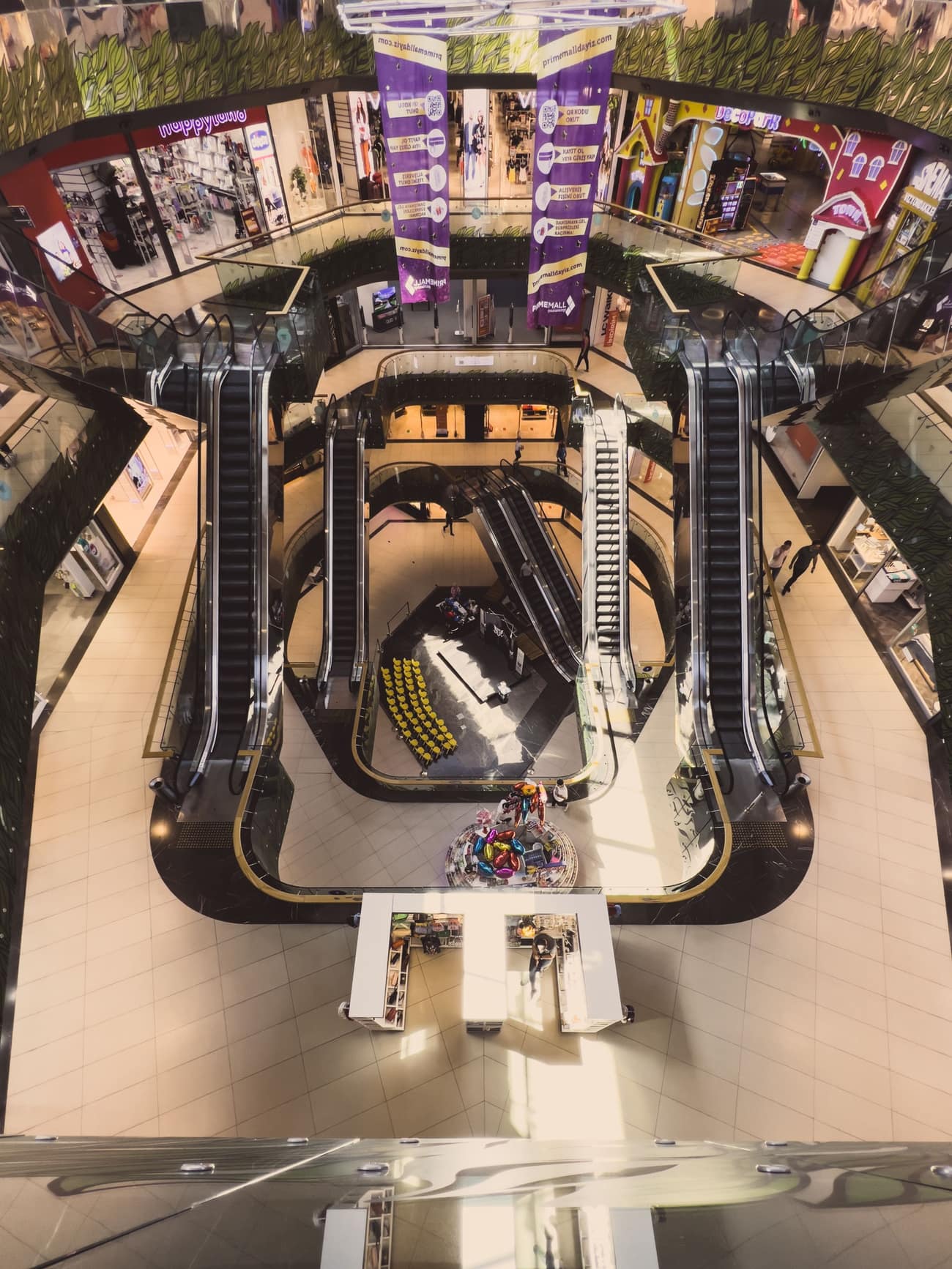 Overhead view of shoppers moving through a busy shopping center concourse
