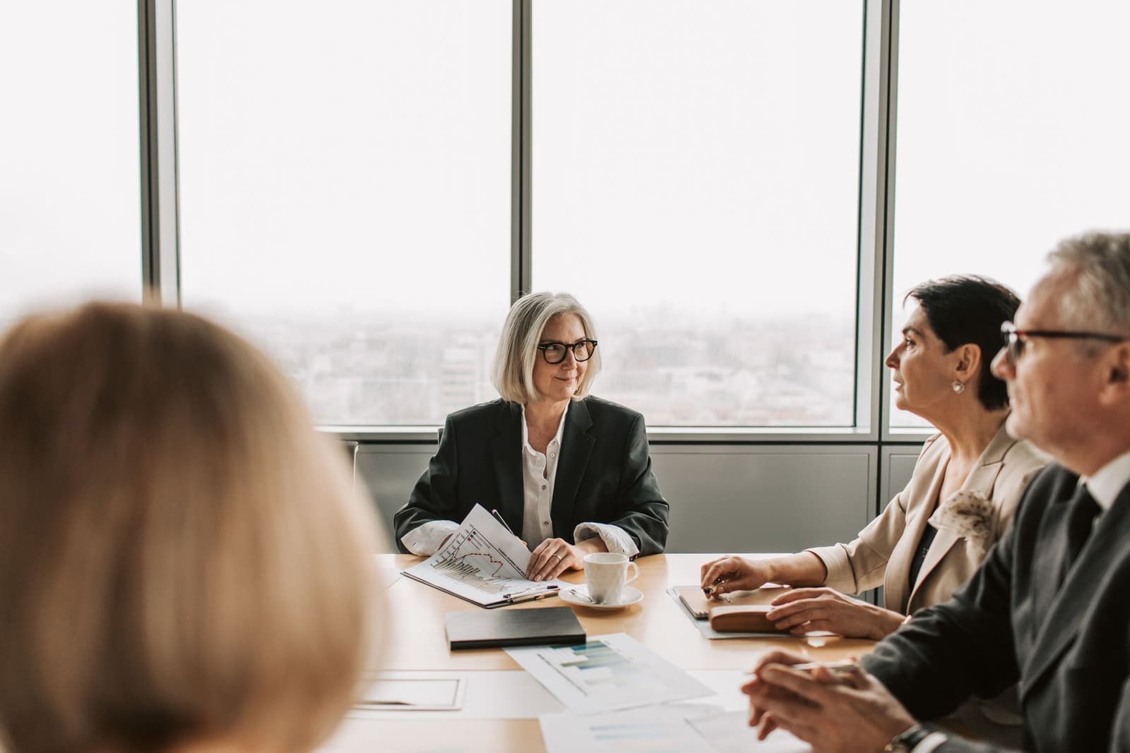 A lease administration team working through documents in a meeting room
