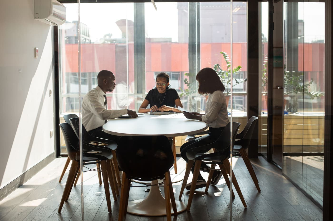A modern boardroom overlooking a city